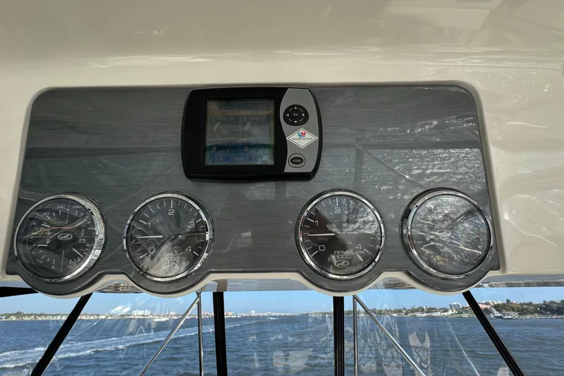 Slide: The Image of Dashboard of 2005 Sea Ray 500 Sedan Bridge with gauges and navigation display. - 53