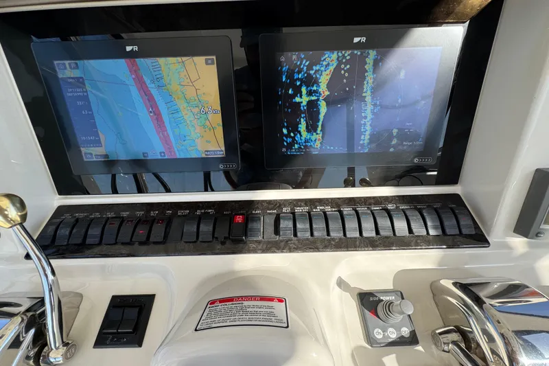 Slide: The Image of Control panel of a 2005 Sea Ray 500 Sedan Bridge with navigation screens. - 54