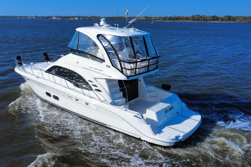 Slide: The Image of 2005 Sea Ray 500 Sedan Bridge yacht cruising on open water. - 7
