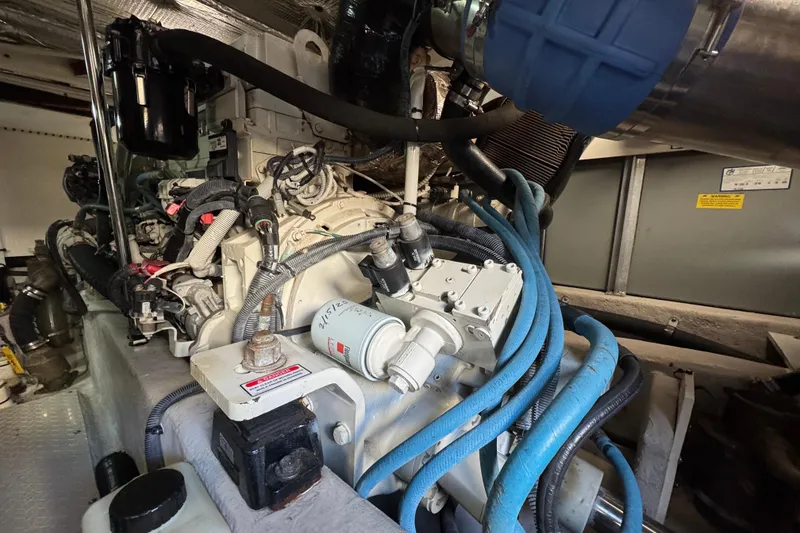 Slide: The Image of Engine compartment of a 2005 Sea Ray 500 Sedan Bridge with visible hoses and components. - 72