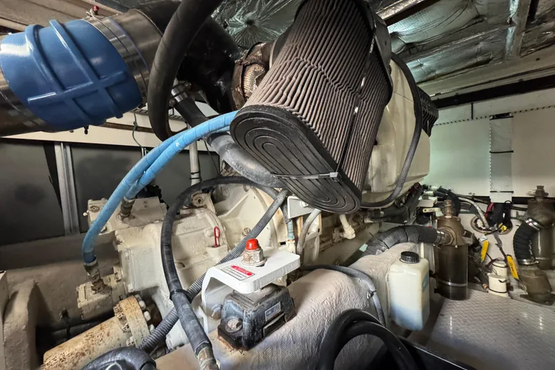 Slide: The Image of Engine room of a 2005 Sea Ray 500 Sedan Bridge yacht, showcasing mechanical components. - 74