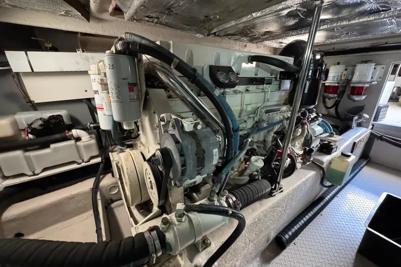 Slide: The Image of Engine room of a 2005 Sea Ray 500 Sedan Bridge yacht, showcasing mechanical components. - 77
