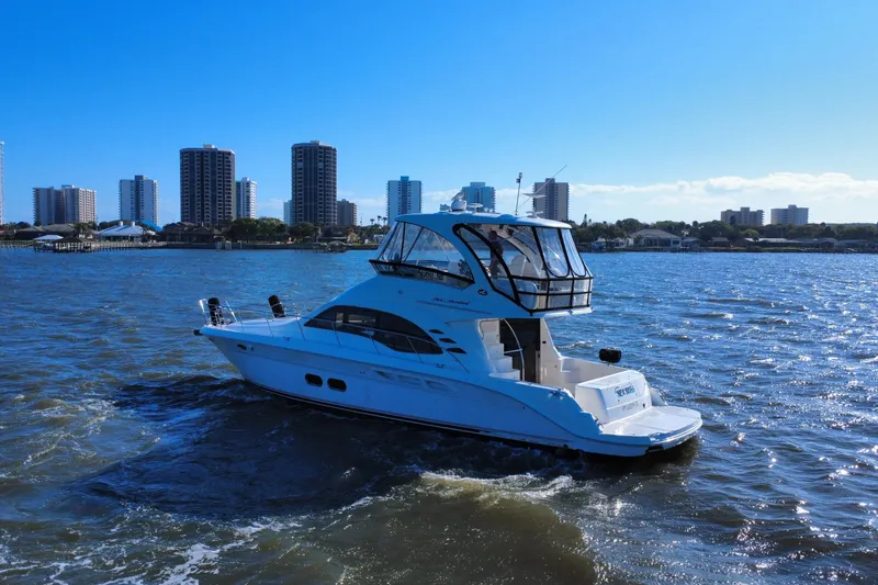 Slide: The Image of 2005 Sea Ray 500 Sedan Bridge yacht cruising near city skyline on a sunny day. - 8
