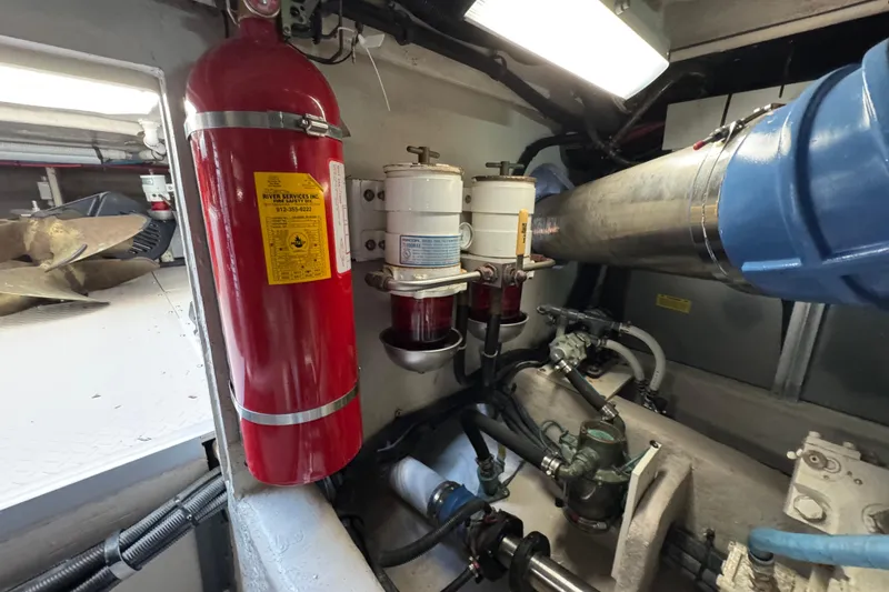 Slide: The Image of Engine room of 2005 Sea Ray 500 Sedan Bridge with fire extinguisher and fuel filters. - 81