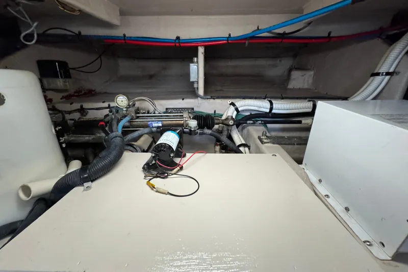 Slide: The Image of Engine room of a 2005 Sea Ray 500 Sedan Bridge with visible wiring and components. - 84
