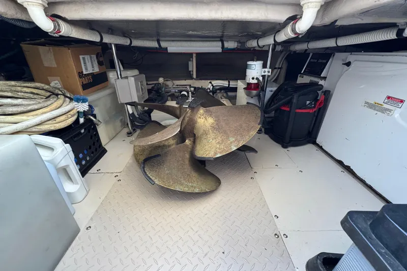 Slide: The Image of Engine room of 2005 Sea Ray 500 Sedan Bridge with large propeller and equipment. - 85