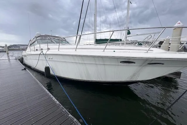 The Image of 1999 Sea Ray 500 Sundancer yacht docked on a cloudy day. - 0