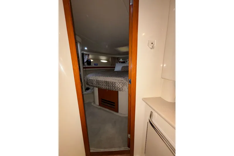 Slide: The Image of Interior cabin view of a 1999 Sea Ray 480 Sedan Bridge yacht, featuring a cozy bed. - 79