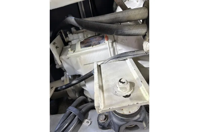 Slide: The Image of Engine compartment of a 1999 Sea Ray 480 Sedan Bridge boat, showing mechanical components. - 90