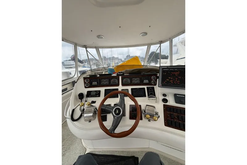 Slide: The Image of 1999 Sea Ray 480 Sedan Bridge helm with steering wheel, controls, and navigation equipment. - 20