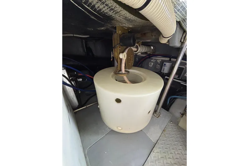 Slide: The Image of Engine room of 1999 Sea Ray 480 Sedan Bridge with mechanical components and wiring. - 97