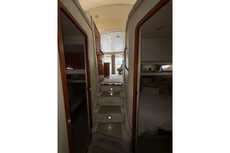 Slide: The Image of Interior view of 1999 Sea Ray 480 Sedan Bridge yacht, featuring stairs and cabin doors. - 81