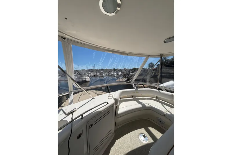 Slide: The Image of 1999 Sea Ray 480 Sedan Bridge interior with marina view through clear windows. - 16