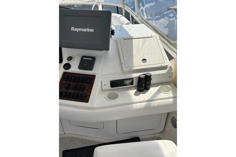 Slide: The Image of 1999 Sea Ray 480 Sedan Bridge helm with Raymarine electronics and binoculars. - 29