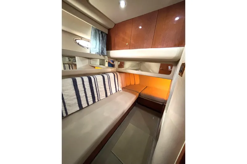 Slide: The Image of Interior cabin of 1999 Sea Ray 480 Sedan Bridge with cozy seating and wooden cabinetry. - 61