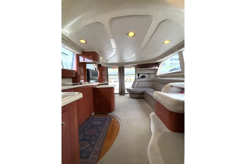 Slide: The Image of Luxurious interior of a 1999 Sea Ray 480 Sedan Bridge yacht with elegant seating and cabinetry. - 49