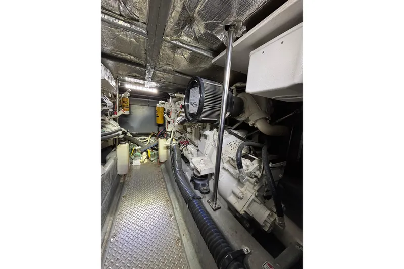 Slide: The Image of Engine room of a 1999 Sea Ray 480 Sedan Bridge, showcasing mechanical components and equipment. - 83