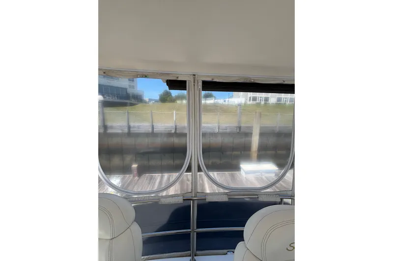 Slide: The Image of Interior view from a 1999 Sea Ray 480 Sedan Bridge yacht, showing dockside scenery. - 32