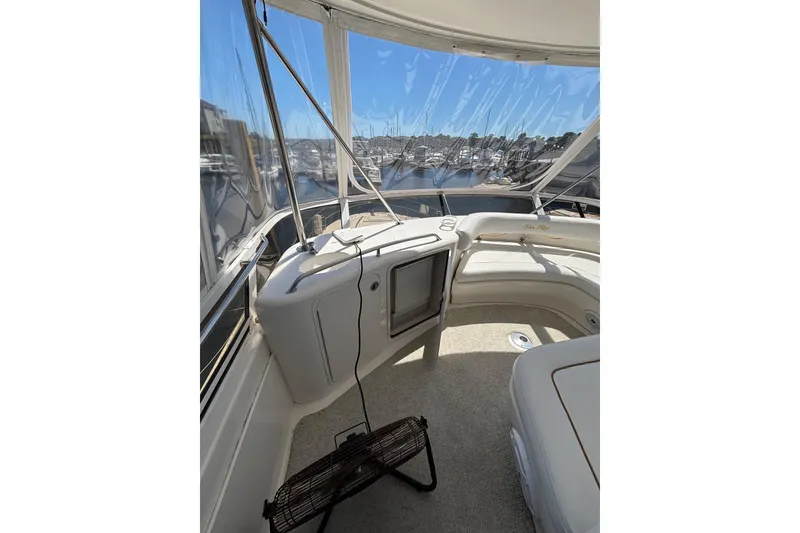 Slide: The Image of 1999 Sea Ray 480 Sedan Bridge interior with panoramic marina view. - 17