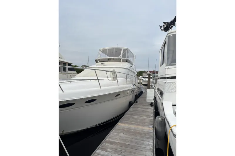 Slide: The Image of 1999 Sea Ray 480 Sedan Bridge yacht docked at marina. - 2