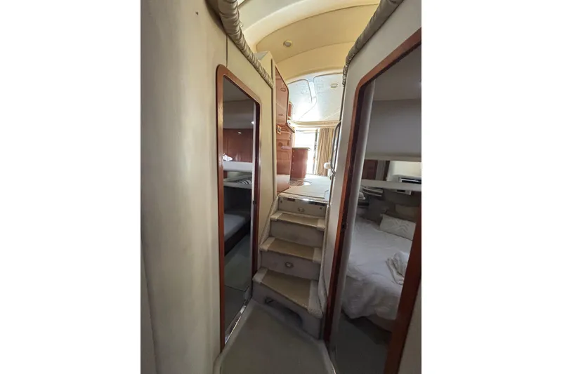 Slide: The Image of Interior view of 1999 Sea Ray 480 Sedan Bridge yacht, featuring stairs and cabin rooms. - 52