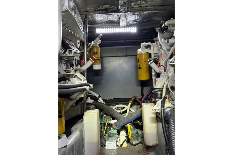 Slide: The Image of Engine room of a 1999 Sea Ray 480 Sedan Bridge with visible components and wiring. - 93