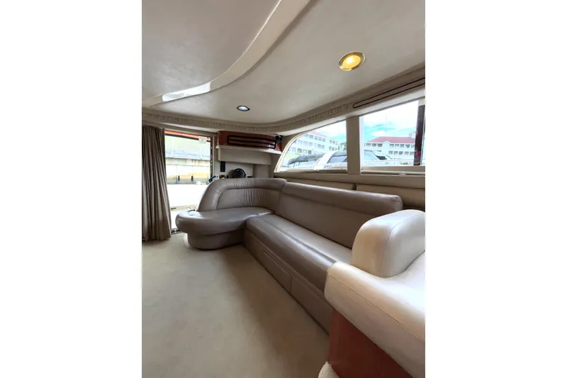 Slide: The Image of Luxurious interior of 1999 Sea Ray 480 Sedan Bridge yacht with plush seating. - 38