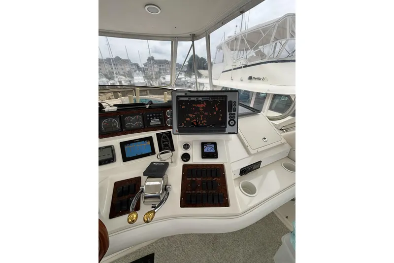 Slide: The Image of Cockpit of 1999 Sea Ray 480 Sedan Bridge with navigation equipment and controls. - 22