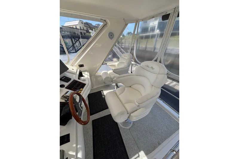 Slide: The Image of Luxurious interior of 1999 Sea Ray 480 Sedan Bridge with plush captain's chairs. - 27