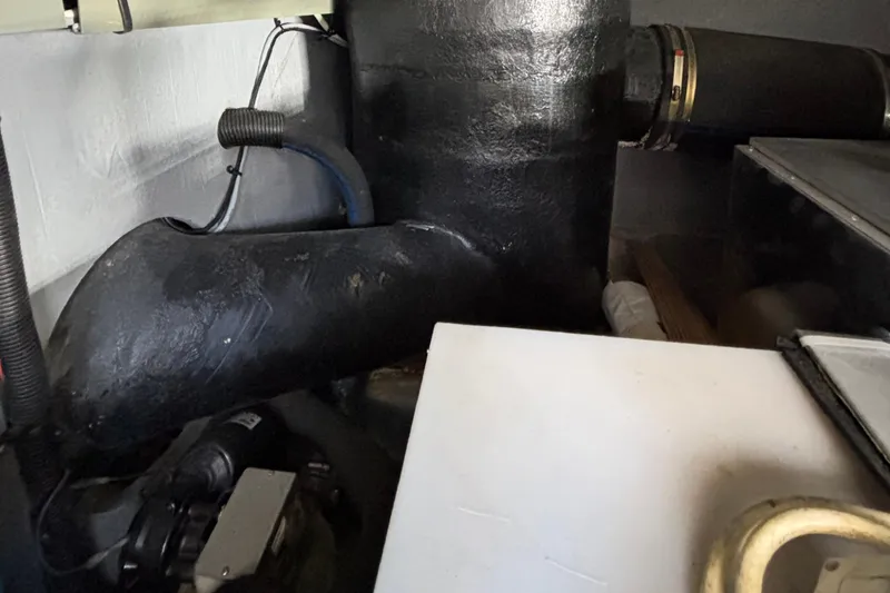 Slide: The Image of Engine room of a 1999 Sea Ray 480 Sedan Bridge yacht, showcasing mechanical components. - 95