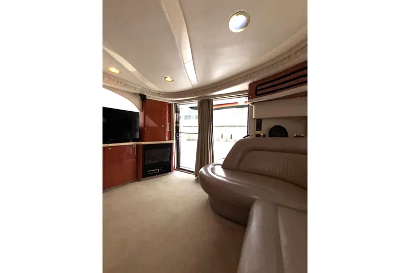 Slide: The Image of Luxurious interior of 1999 Sea Ray 480 Sedan Bridge yacht with plush seating and entertainment system. - 40