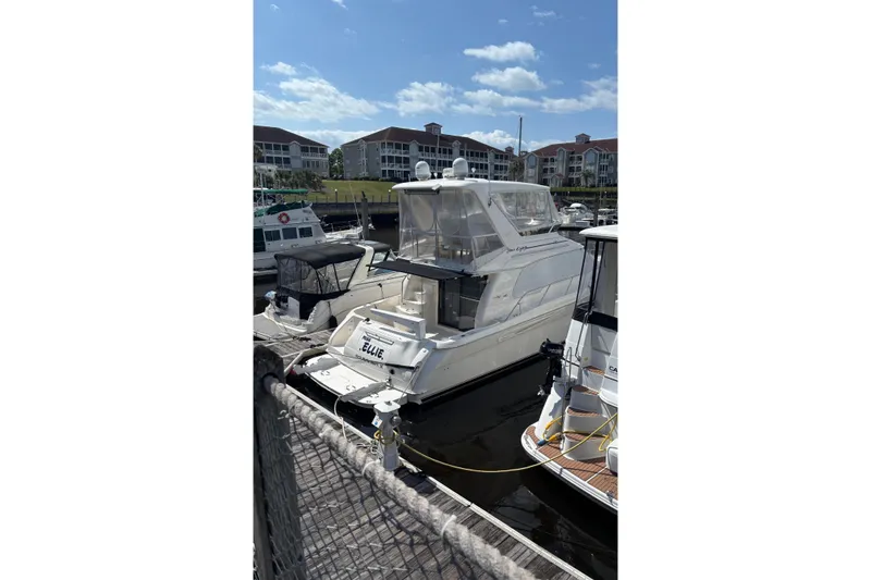Slide: The Image of 1999 Sea Ray 480 Sedan Bridge yacht docked at marina under blue sky. - 37