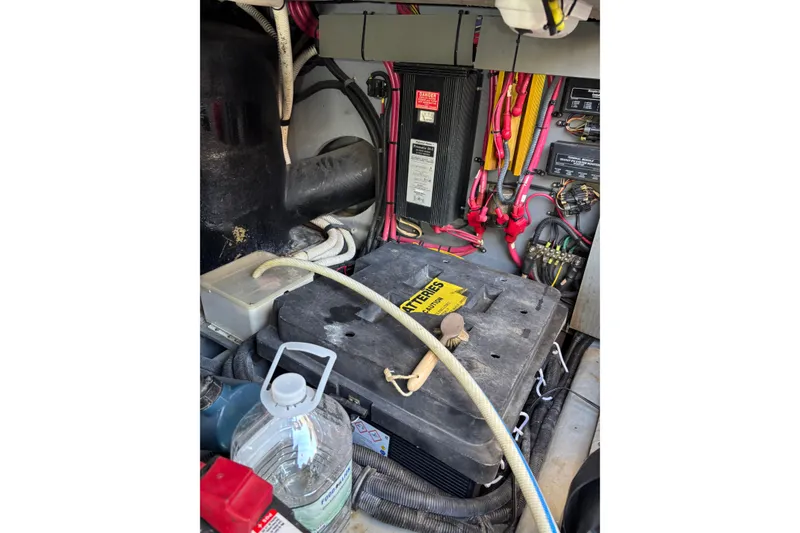 Slide: The Image of Engine compartment of a 1999 Sea Ray 480 Sedan Bridge with battery and wiring. - 103
