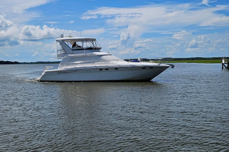 The Image of 1999 Sea Ray 480 Sedan Bridge yacht cruising on a sunny day. - 0