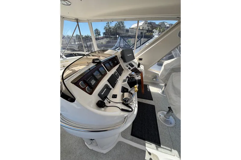 Slide: The Image of 1999 Sea Ray 480 Sedan Bridge helm with navigation equipment and panoramic windows. - 26