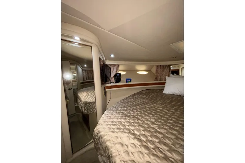Slide: The Image of Luxurious interior cabin of 1999 Sea Ray 480 Sedan Bridge yacht with cozy bedding. - 71