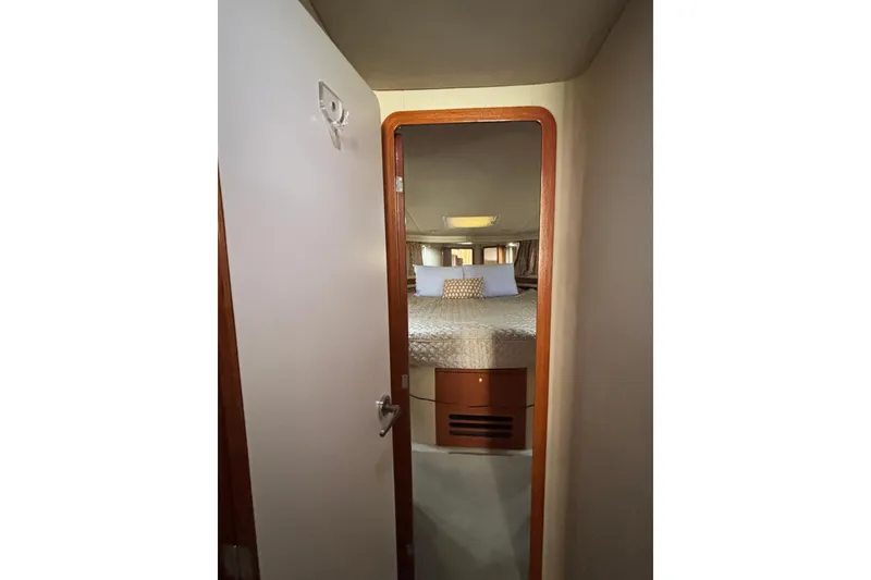 Slide: The Image of Interior view of 1999 Sea Ray 480 Sedan Bridge bedroom through open door. - 56