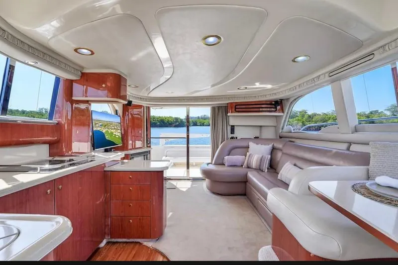 Slide: The Image of Luxurious interior of 1999 Sea Ray 480 Sedan Bridge yacht with elegant seating and modern amenities. - 8