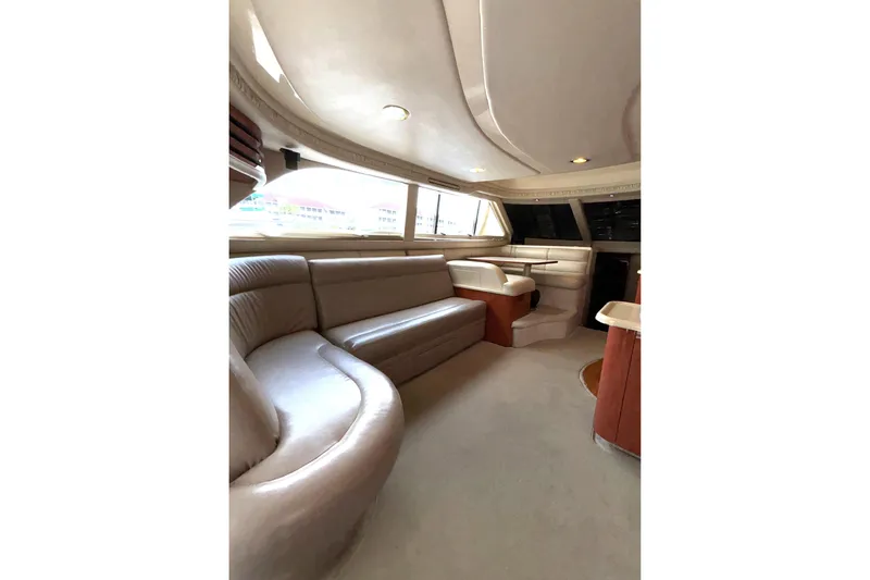 Slide: The Image of Luxurious interior of a 1999 Sea Ray 480 Sedan Bridge yacht with plush seating. - 39