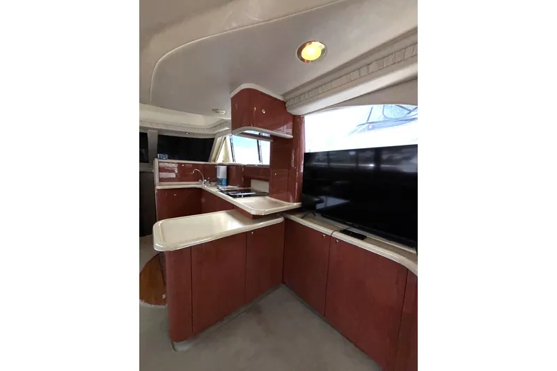 Slide: The Image of Interior of 1999 Sea Ray 480 Sedan Bridge yacht with modern kitchen and sleek cabinetry. - 47