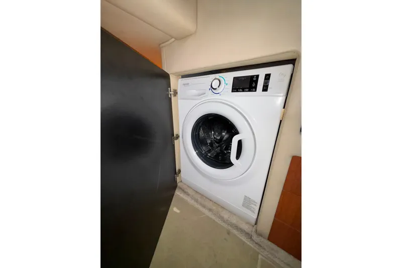 Slide: The Image of Washing machine inside 1999 Sea Ray 480 Sedan Bridge yacht compartment. - 65