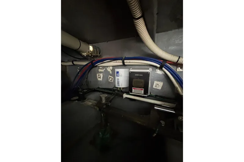 Slide: The Image of Electrical wiring and components inside a 1999 Sea Ray 480 Sedan Bridge boat. - 99