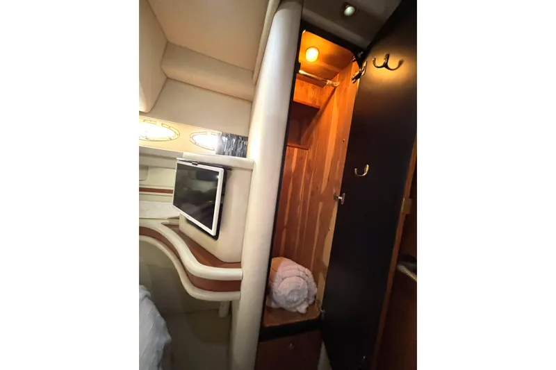 Slide: The Image of 1999 Sea Ray 480 Sedan Bridge interior with TV and open closet. - 55