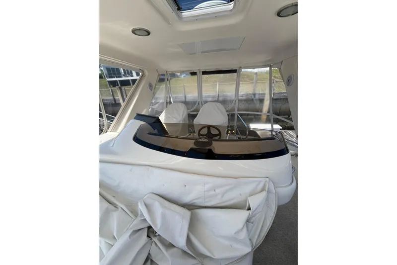 Slide: The Image of 1999 Sea Ray 480 Sedan Bridge helm with covered seating and panoramic windows. - 25