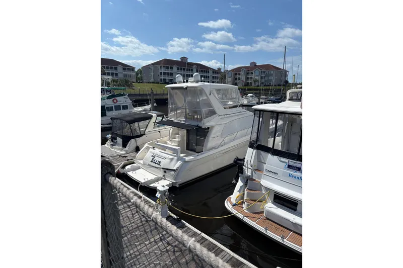 Slide: The Image of 1999 Sea Ray 480 Sedan Bridge yacht docked at marina under blue sky. - 36