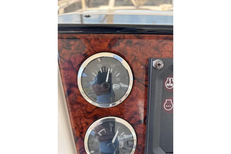 Slide: The Image of Dashboard gauges of a 1999 Sea Ray 480 Sedan Bridge boat. - 23
