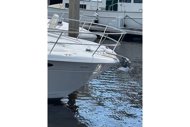 Slide: The Image of 1999 Sea Ray 480 Sedan Bridge yacht docked on calm water. - 14