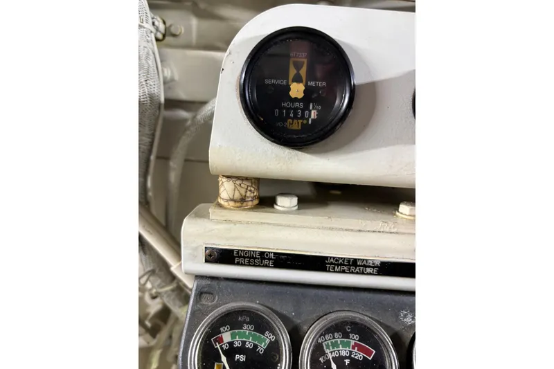 Slide: The Image of Instrument panel of a 1999 Sea Ray 480 Sedan Bridge showing engine hours and gauges. - 85