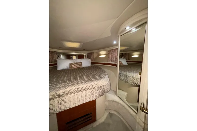 Slide: The Image of Luxurious bedroom interior of 1999 Sea Ray 480 Sedan Bridge yacht with elegant bedding. - 74