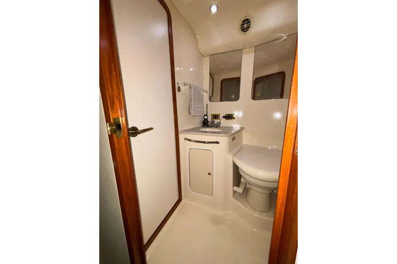 Slide: The Image of Bathroom interior of 1999 Sea Ray 480 Sedan Bridge yacht, featuring sink and toilet. - 60